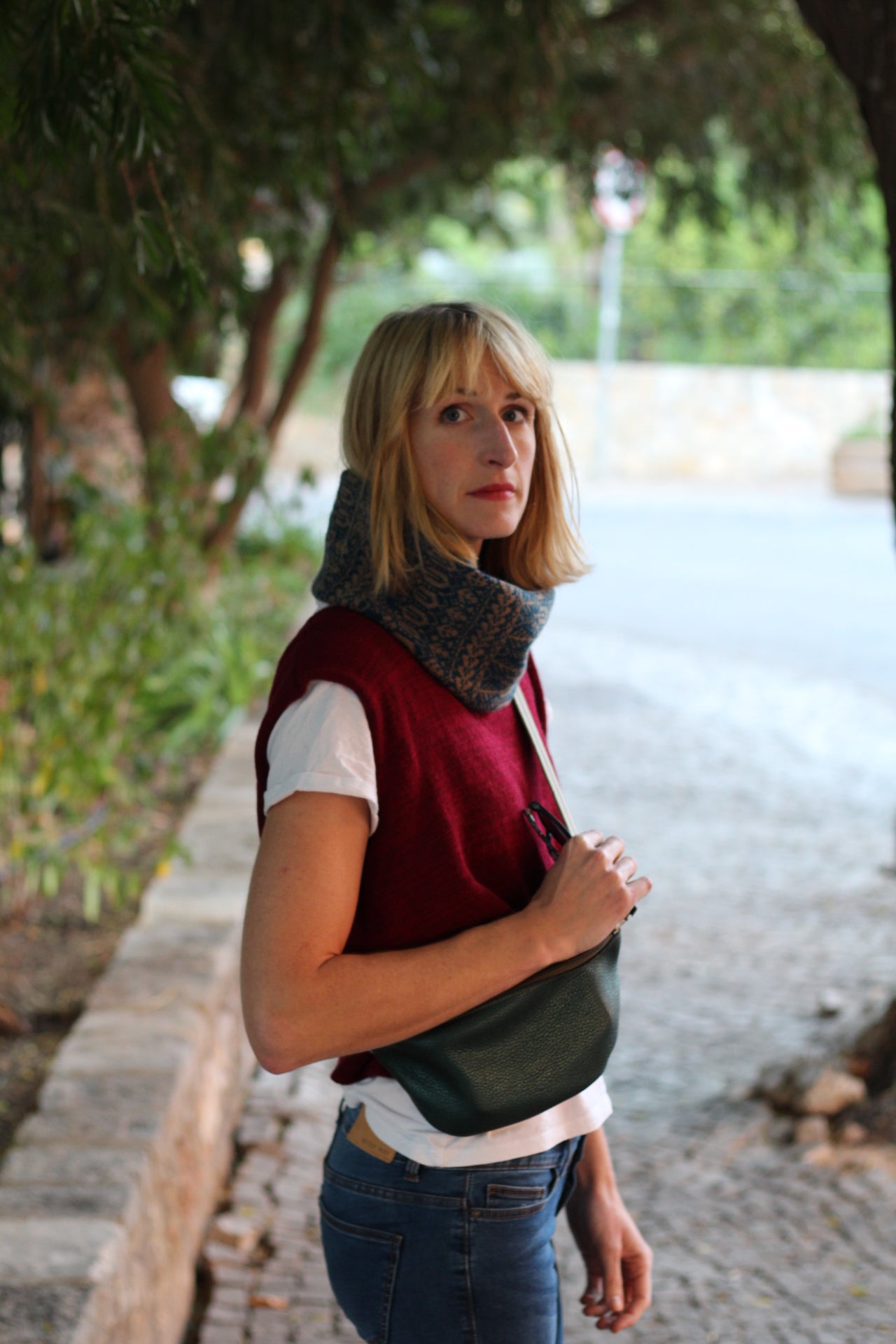 Person standing outdoors with a blurred background