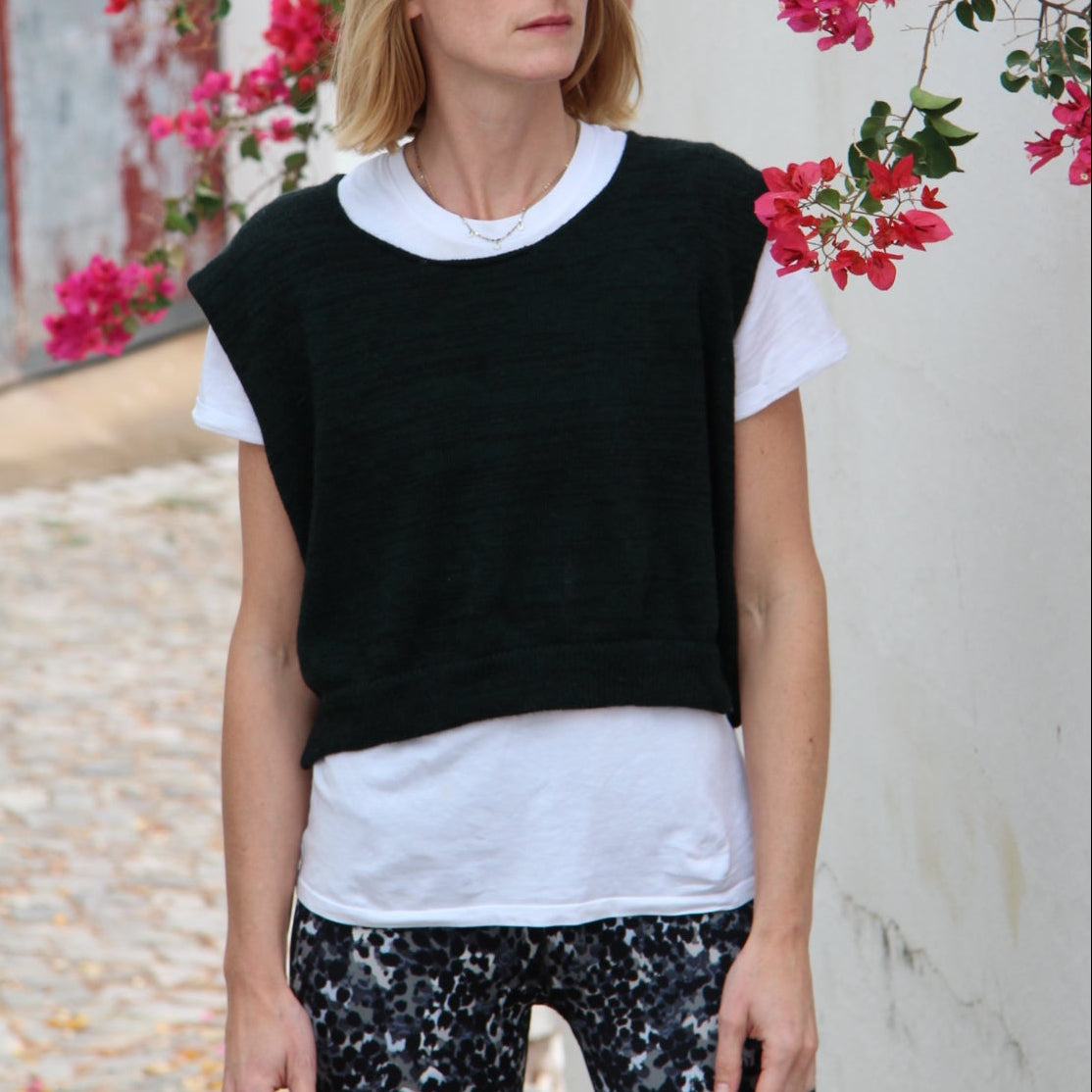Woman lying on a white surface with pink flowers around her